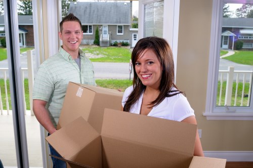 Local moving team organizing belongings in Harlington