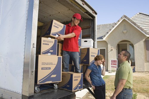 Careful unloading of boxes and furniture at a new Harlington home