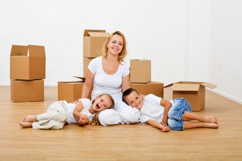 Professional movers handling bulky furniture in a Harlington property